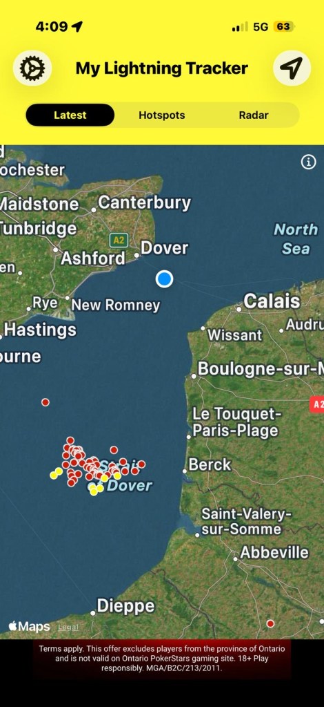 Map showing the My Lightning Tracker application with a focus on the Dover area and surrounding seas, highlighting lightning strike locations in red and yellow.
