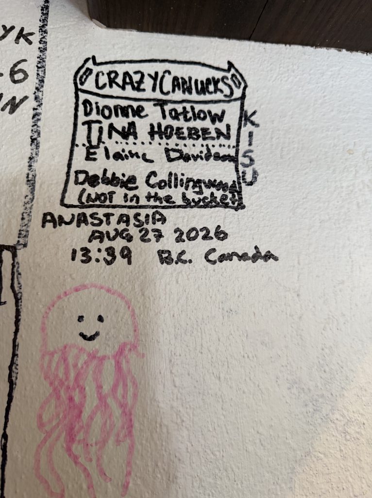 A hand-drawn note titled 'CRAZY CANUCKS' featuring names: Dionne Tatlow, Tim Hoeben, Elaine Davidson, and Debbie Collingwood (not in the bucket). Includes the date 'August 27, 2026,' time '13:39,' and location 'B.C. Canada.' A pink jellyfish drawing with a smiling face is also present.